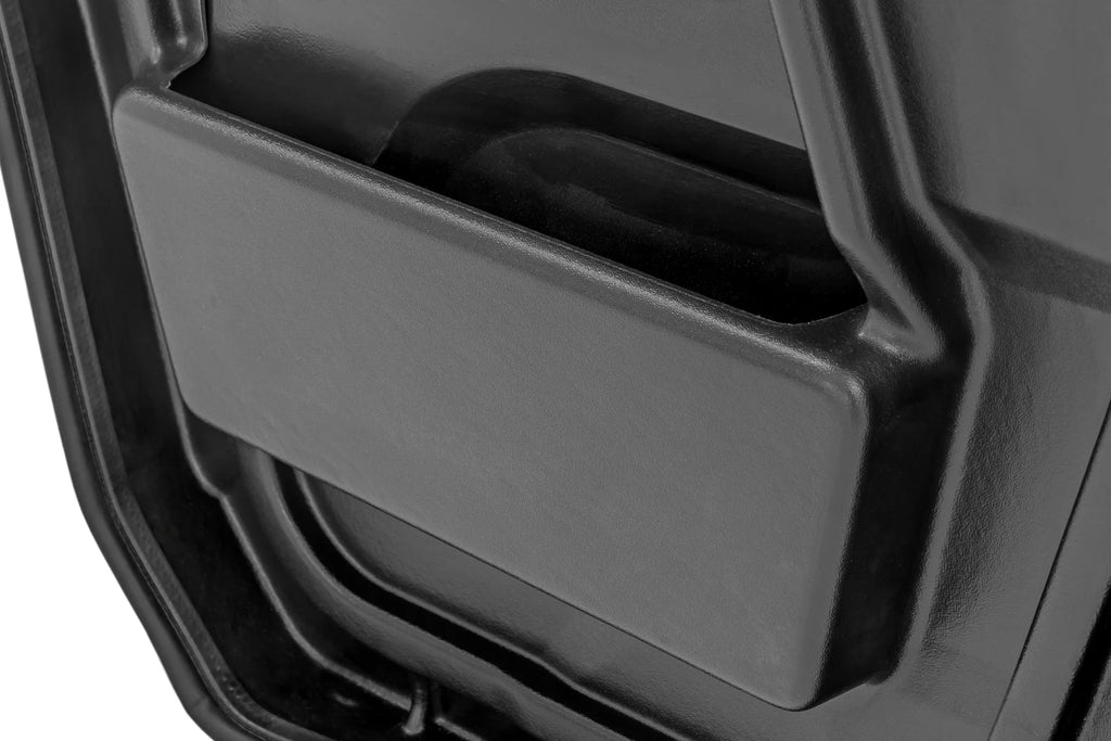 Close-up of a black storage pocket inside the door panel of a 2 Seater Can-Am Defender (HD 5/7/8/9/10), featuring smooth, angled sides and empty interior, with part of the car door’s trim visible around it.