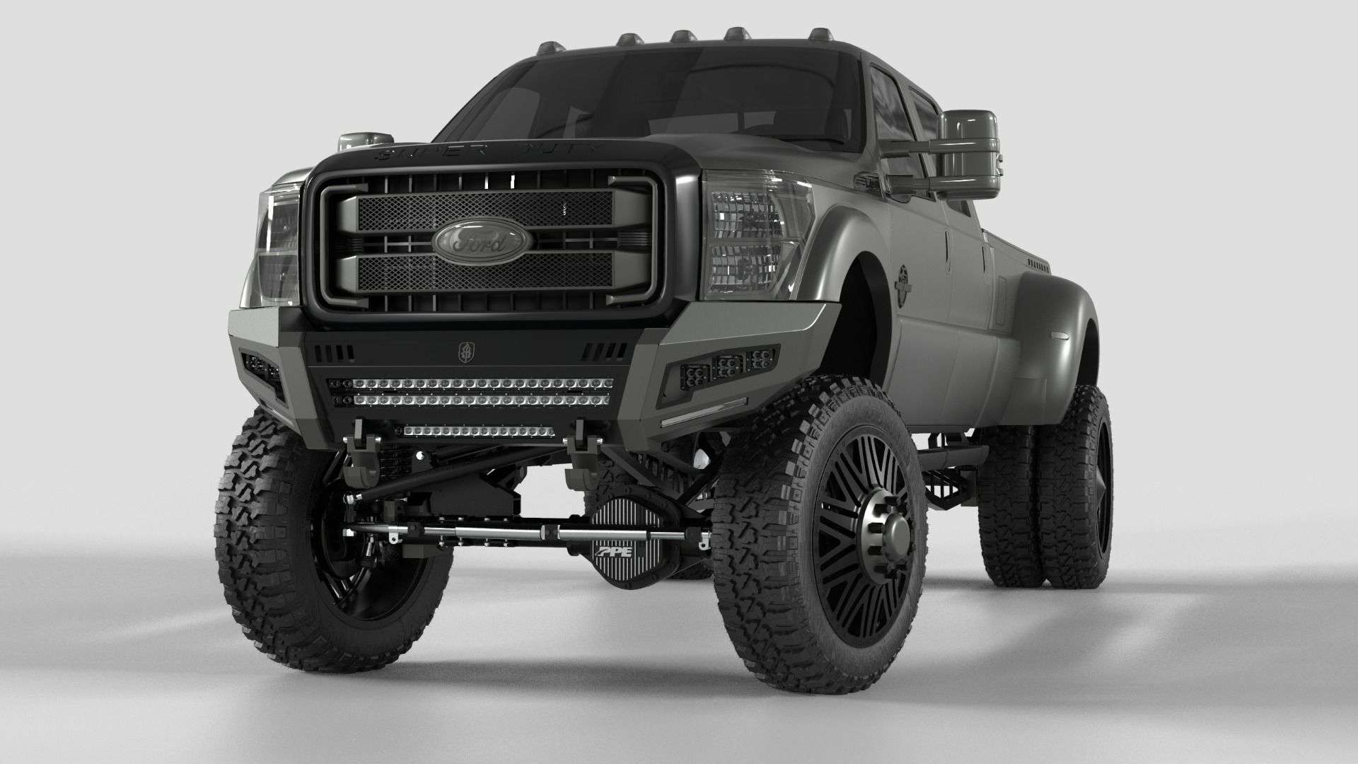 A 2011-2016 Ford F-250 with a matte gray lift and big off-road tires features the Identity Front Bumper Full Kit—center section shackle, wide end pods, X3 cube light pods, accent lights, and black ring—for a rugged look.