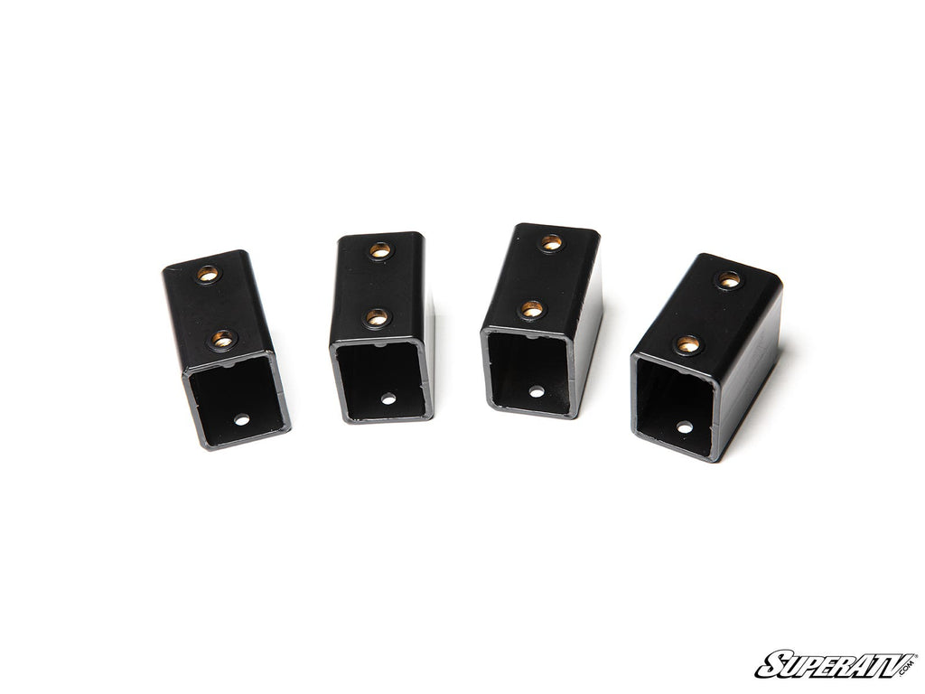 Four black rectangular metal seat risers for Polaris RZR PRO XP, each with open square ends and two screw holes, are arranged in a row on a white background. The SuperATV logo appears in stylized text at the bottom right corner.