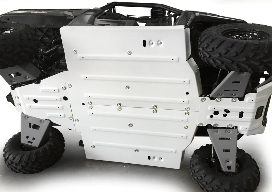 A close-up of a Polaris Ranger 570 / 900 / 1000 XP / Diesel Alloy Full Skidplate Kit shows the large silver skid plate secured with bolts, with rugged knobby tires and parts of the suspension visible around the edges.