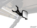 The Can-Am 17 Curved Rear View Mirror, featuring a black adjustable clamp mount, is attached to a vehicles metal roof frame. The background is mainly white with the SuperATV logo in the lower right corner.
