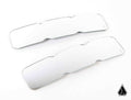 Two identical Assault Industries Bomber Convex Center Mirror Glass Replacement lenses with contoured edges are side by side on a white background, each featuring a small engraved logo, with a geometric black logo at the image’s bottom right.