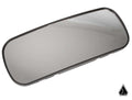 The Assault Industries Stealth Series Convex Rear View Mirror features a rectangular, slightly curved design with a black frame. Photographed on white, it reflects faint gradients and displays a small black geometric logo in the bottom right corner.