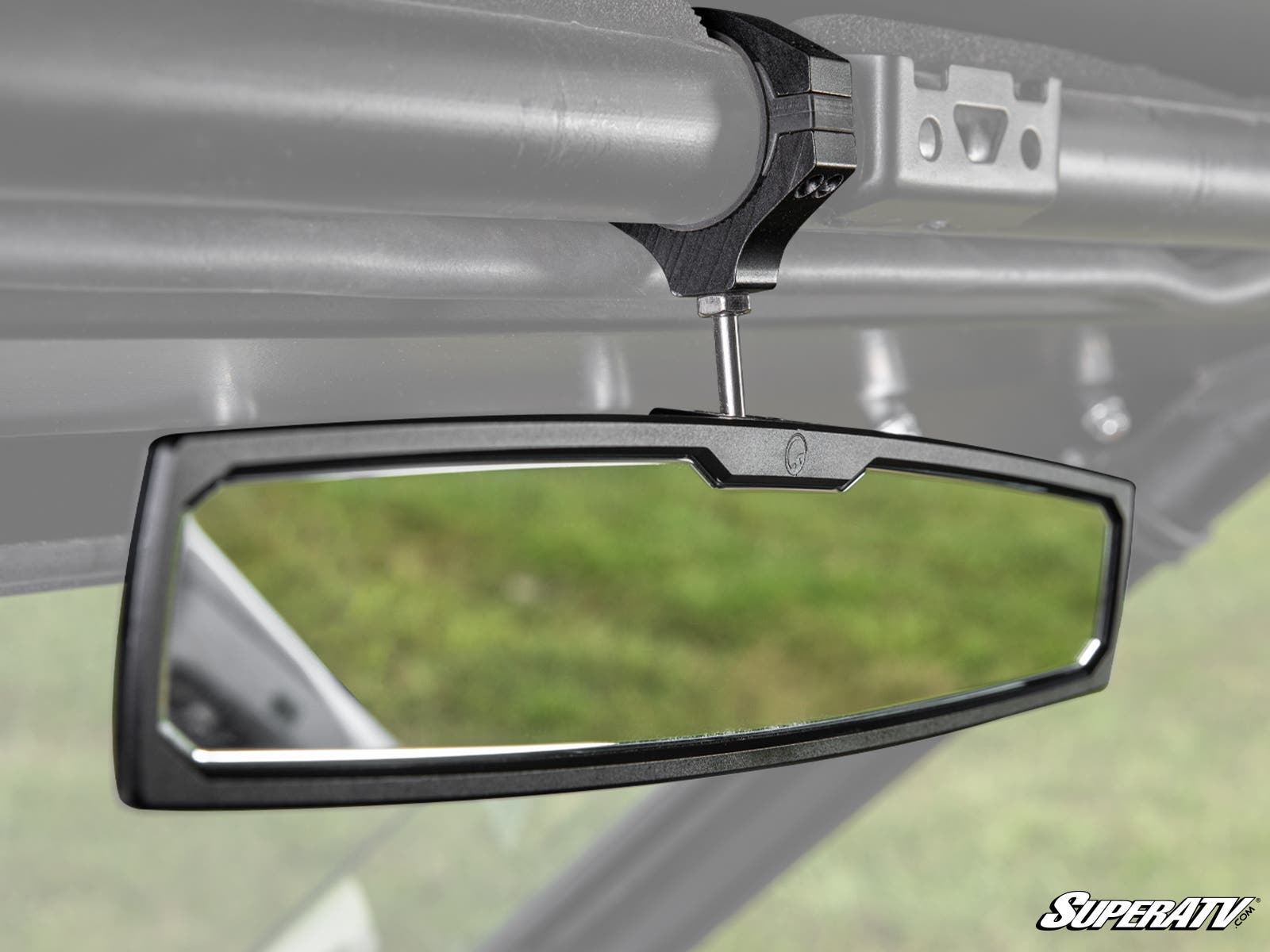 The Polaris Ranger Aluminum Rear-View Mirror, featuring a black frame and mounted with a clamp and bolt to a metal frame inside a vehicle, reflects a green outdoor scene. The SuperATV logo appears in the bottom right corner.