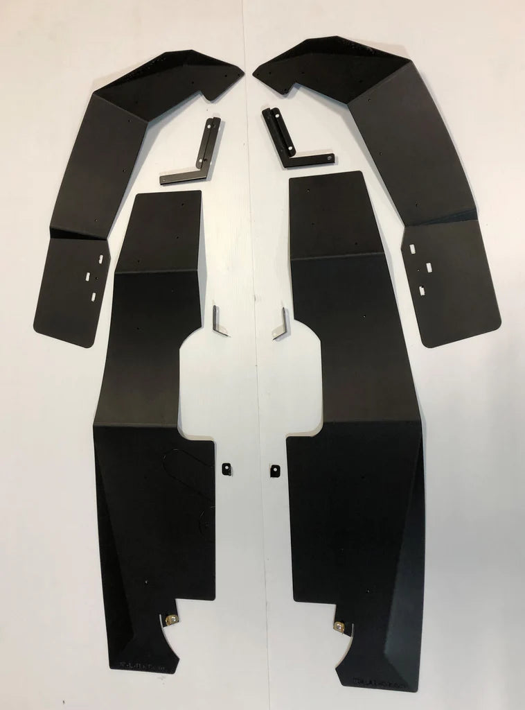 Two sets of large, flat black metal panels with angled edges and cutouts, plus smaller brackets and screws, are arranged on a white surface—components of the RZR XP 1000/XP Turbo/XP Turbo S Mud Flap Fender Extensions.