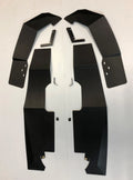 Two sets of large, flat black metal panels with angled edges and cutouts, plus smaller brackets and screws, are arranged on a white surface—components of the RZR XP 1000/XP Turbo/XP Turbo S Mud Flap Fender Extensions.
