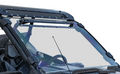 Close-up of a Polaris RZR Pro XP Scratch Resistant Vented Full Windshield with clear glass, visible bolts, and wipers on a utility vehicle’s metal roof and frame; the steering wheel and dashboard are visible through the windshield. Background is plain whi