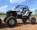 A Polaris Rzr Xp 1000 with an S3 Power Sports 2014+ 8 Lift Kit features large mud-terrain tires and chrome wheels, parked on dirt by shallow water under a bright sky. An orange flag is attached to the roll cage in the background.