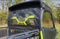 The Segway UT10 - Upper Door/Rear Window Combo is shown installed on a black and green UTV, with clear plastic windows exposing the bright green frame and yellow-green handlebars. The vehicle is parked outside near trees and tall grass.