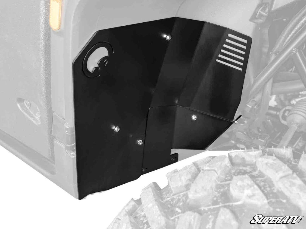 Close-up of Segway Fugleman Inner Fender Guards, black metal, installed on an off-road vehicle to protect the inner fender. Large rugged tire and suspension parts visible against a white background. SuperATV logo shown bottom right.