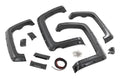 Displayed on a white background are four black plastic fender flares, mounting brackets, screws, wiring, and clips—components from the Fender Flares | Defender 59 Bed kit for Chevy Silverado 1500 2WD/4WD (2014-18 & Classic).