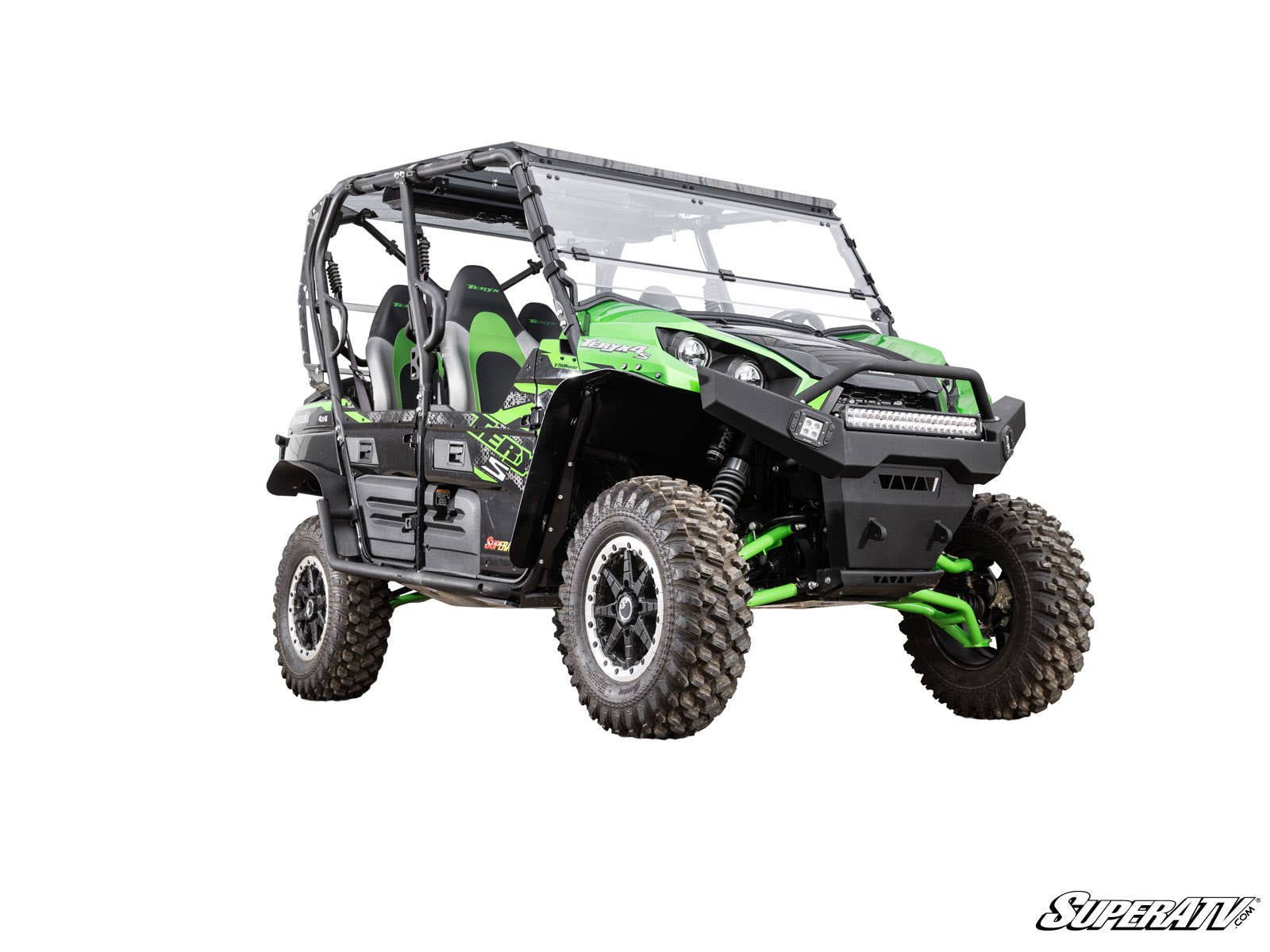 A Kawasaki Teryx S 2 Lift Kit is shown installed on a green and black off-road utility vehicle with four bucket seats, roll cage, rugged tires, and SuperATV branding, angled to showcase its suspension and front grill on a white background.
