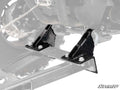 Close-up of sturdy, angular Plow Pro Snow Plow Drop Brackets in black metal, mounted to a vehicle frame with four bolts. The brackets are highlighted against a faded background; SuperATV logo appears in the bottom right corner.