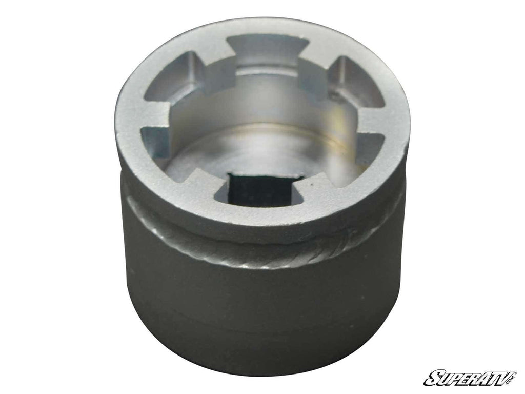 A close-up of the Polaris RZR XP Turbo Spider Shaft Nut Socket Tool with six internal notches, smooth cylindrical sides, and a square drive hole at the base. The “SuperATV” logo is visible in the bottom right corner. The tool appears new and clean.