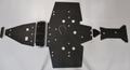 Five black metal plates from the Trail Armor Sportsman 850/850 SP/1000 XP Scrambler 850/1000 XP Full Skid set, each with multiple circular cutouts, are arranged in a row with the largest central plate and smaller plates on either side.