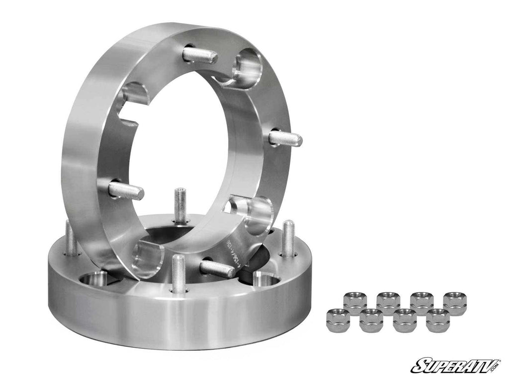 Two Bobcat Wheel Spacer - 4/156 silver metal spacers with multiple studs and holes are shown upright and flat, with ten matching lug nuts in two rows beside them. The SuperATV logo is at the bottom right on a plain white background.