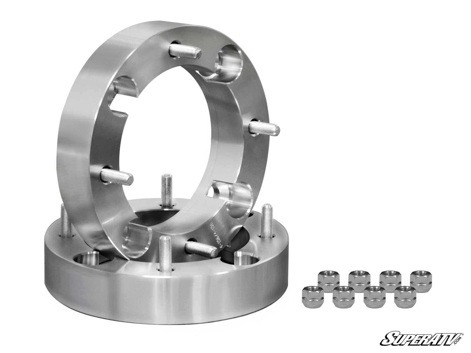 Two shiny Polaris Wheel Spacer - 4/156 units, each with four studs, are stacked—one upright and one flat. Eight lug nuts sit nearby. The SuperATV logo appears in the bottom right on a white background.