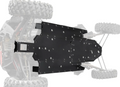A close-up, top-down view shows a Polaris RZR XP 4 Turbo S Full Skid Plate—a black metal, rectangular, hole-punched plate mounted on the vehicle’s underside, with the rest of the off-road vehicle blurred in the background.