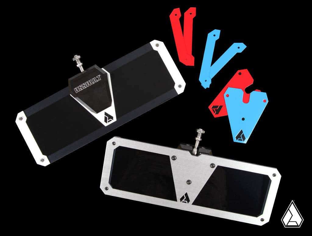 Two rectangular, black-and-metal Assault Industries Ghost Tinted Sun Visors with triangular center plates are shown on a black background. Four blue and red angular bezels are on the right, with a white logo in the bottom right corner.