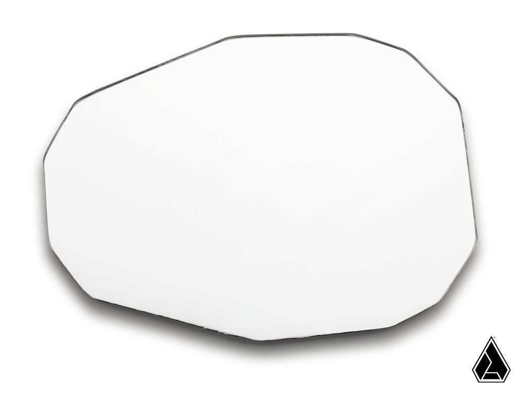 The Assault Industries Convex Replacement Mirror, featuring an irregular octagonal white design with beveled edges, is displayed against a white background. A small black geometric teardrop logo appears in the bottom right corner.