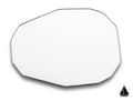 The Assault Industries Convex Replacement Mirror, featuring an irregular octagonal white design with beveled edges, is displayed against a white background. A small black geometric teardrop logo appears in the bottom right corner.