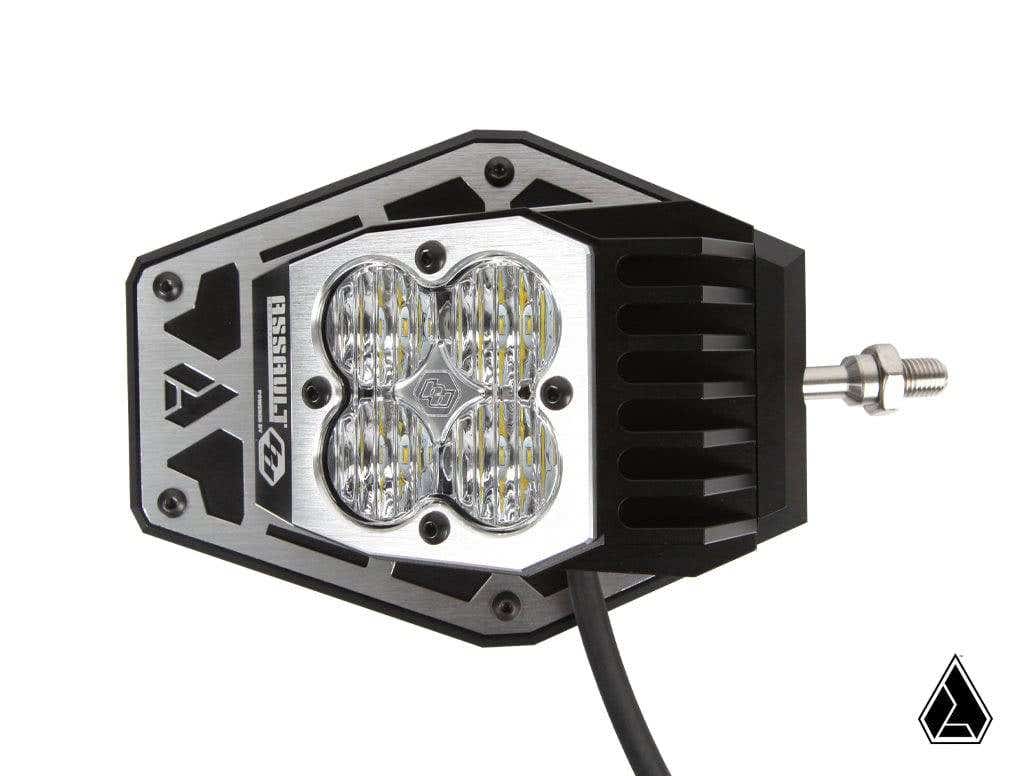 The Assault Industries Nighthawk LED Side Mirrors feature metallic and black housings with four round, textured central lenses, a mounting bolt and cable, geometric logo in the corner, and TIMESSU branding on the housing.