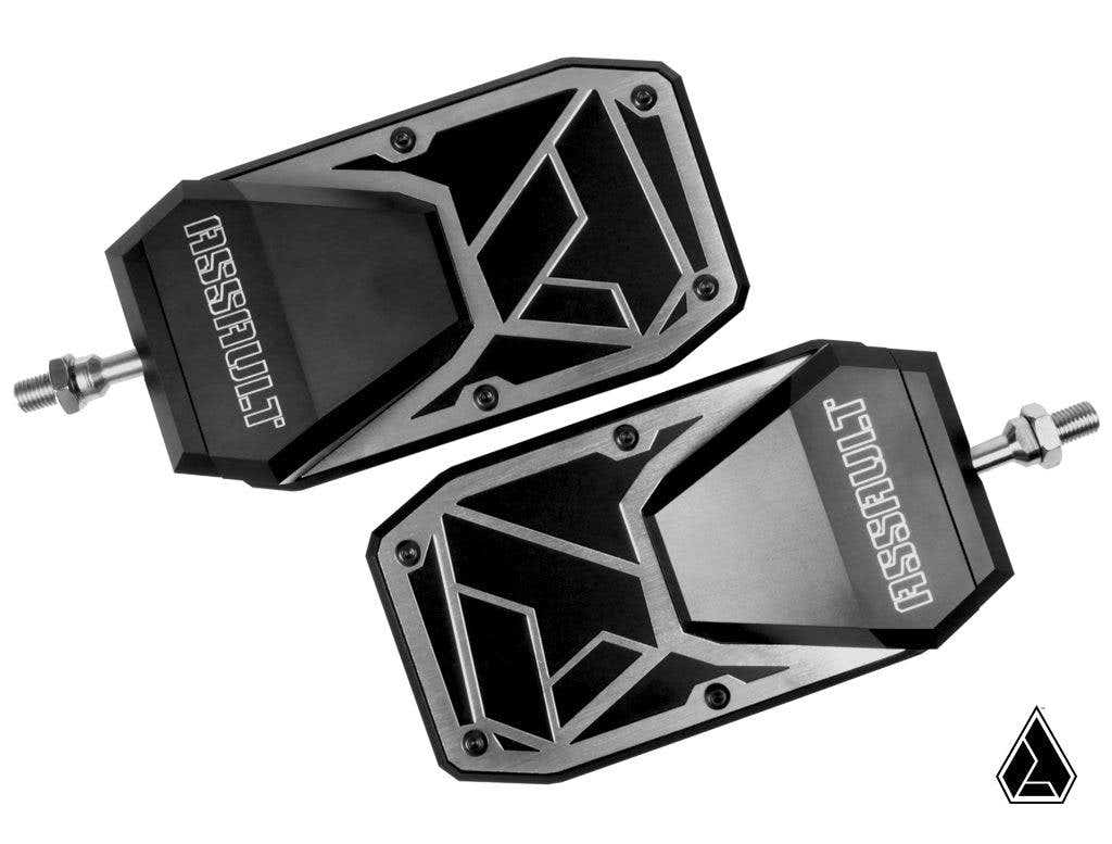 A pair of Assault Industries Phantom Convex Side Mirrors in black and silver with hexagonal shapes, metallic edges, “ASSAULT” engraving, and an angular, futuristic design are displayed on a white background with a small triangular logo.