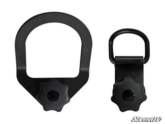 Polaris Sportsman Latch and Go Tie Downs are pictured side by side on a white background. Each black metal anchor features a large loop at the top and a screw knob at the bottom; one is wider and angular, the other narrower and rounder.