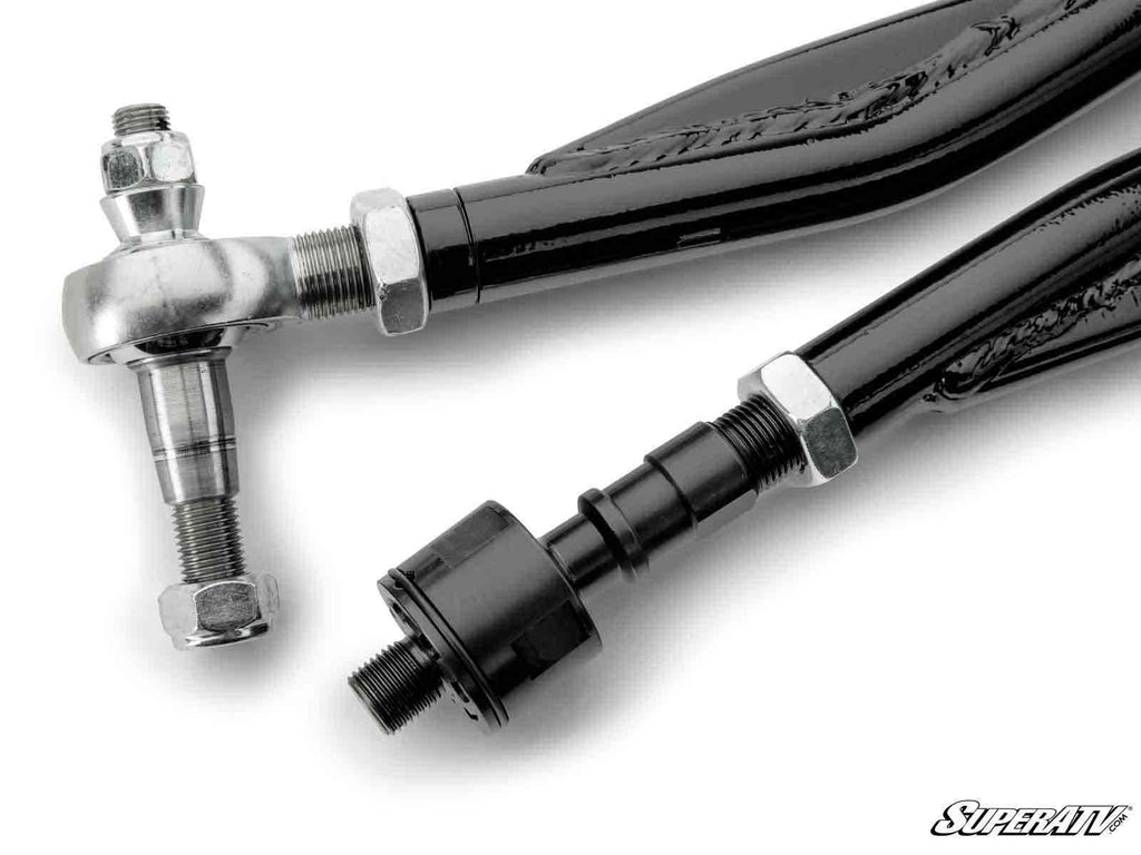 Close-up of two black metal rods from the Can-Am Defender HD8 RackBoss 2.0 Z-Bend Tie Rod Kit, showing threaded ends with silver hex nuts, a joint, a rod end bearing on one side, and a black fitting on the other. SuperATV logo in lower right corner.