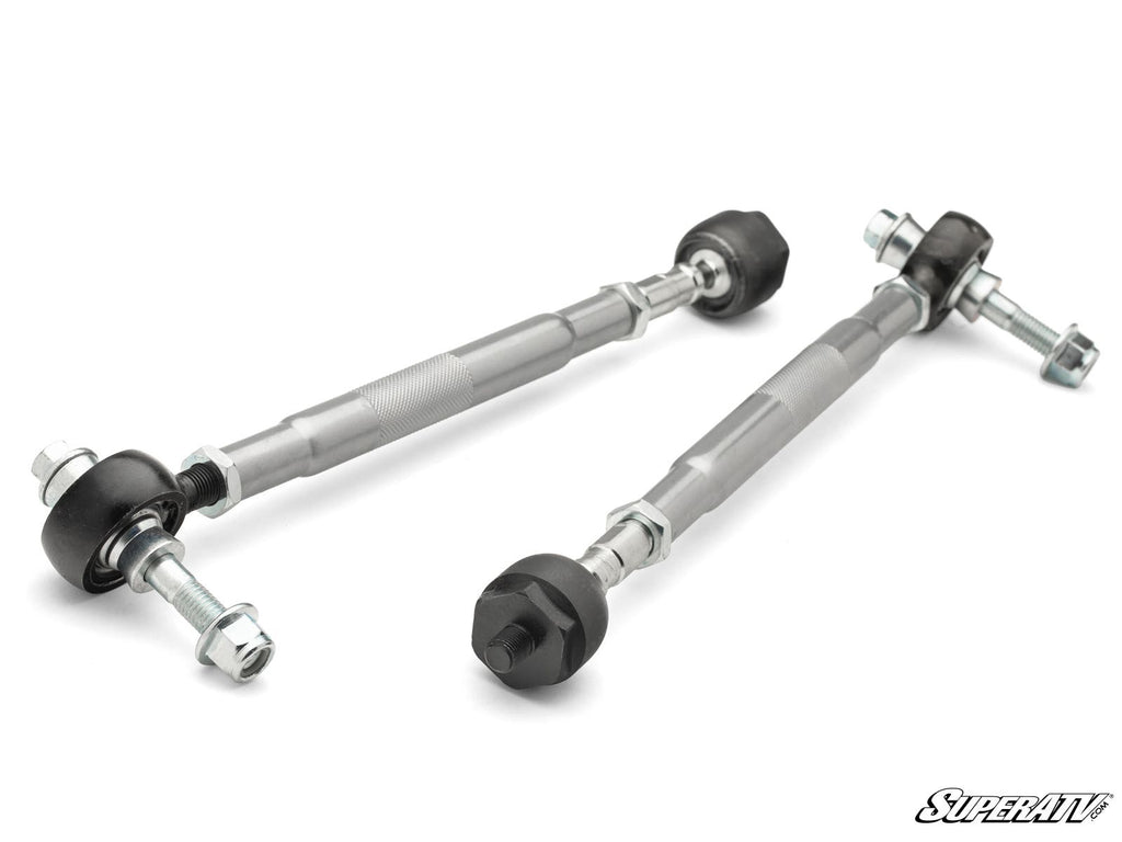 Two Yamaha Wolverine X2/X4 850 Heavy Duty Tie Rods with black ball joints and silver hex adjustment sleeves rest on a white background. Threaded ends have nuts and bolts attached, with a small “SuperATV” logo in the bottom right corner.
