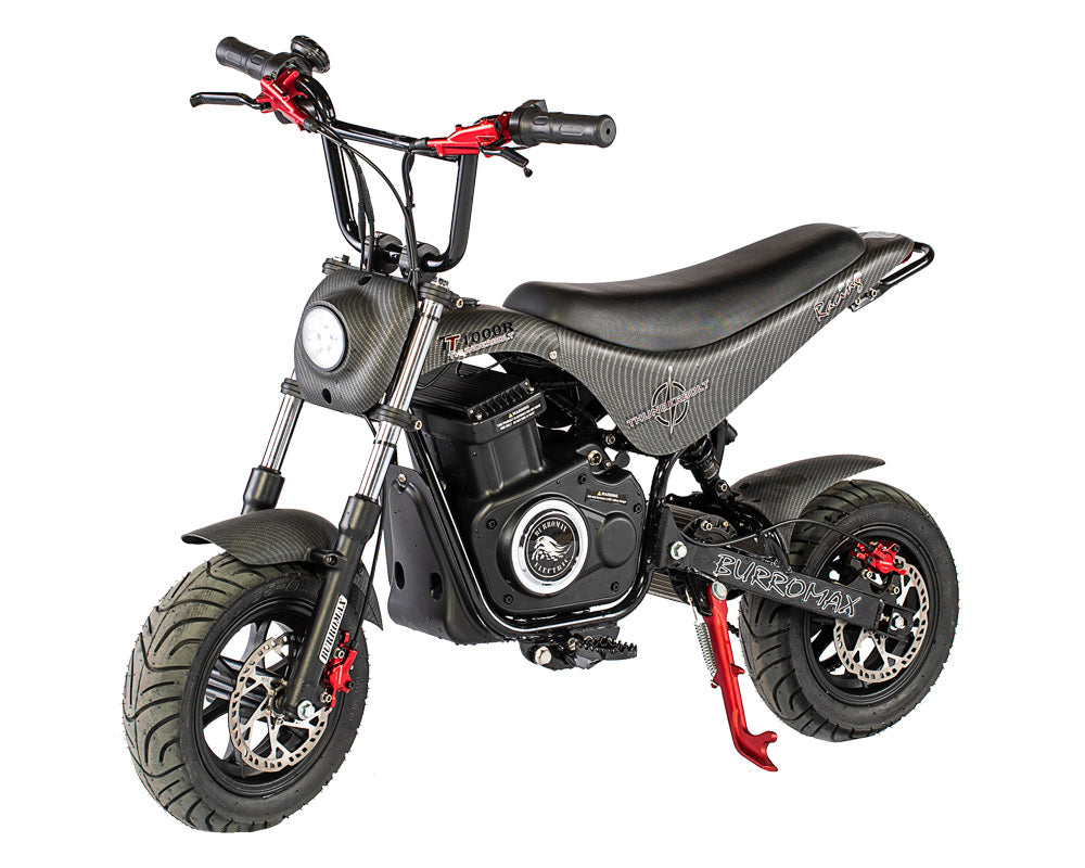 The Burromax TT Max 1.5Kw Electric Supermoto Bike is a small black mini bike with thick tires, red-accented handlebars and brake calipers, a visible headlight, a textured frame marked Supermax, and the side stand down.