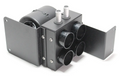 The Inferno Cab Heater Kit With Defrost for 2018-2023 Polaris Rzr Turbo S features a black, rectangular HVAC duct splitter with four front air outlets, two top metal inlet pipes, and side mounting flanges for easy installation.