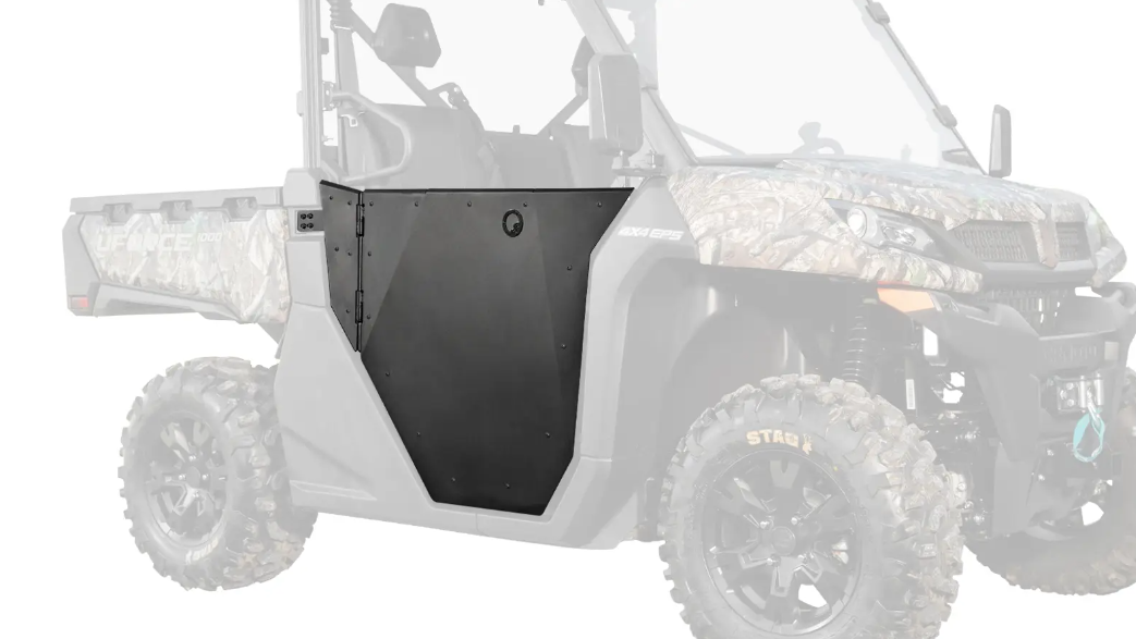 The UForce 1000 Aluminum Half Doors, shown in black, are installed on the side of a partially faded camouflage off-road vehicle with rugged tires, a visible steering wheel, and a front bumper featuring a blue tow hook.