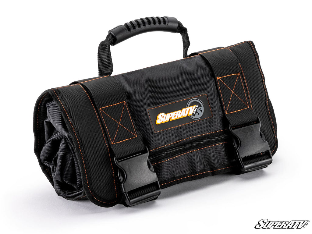 A black Pouch Roll-Up Tool Bag sits on a white background. It has orange stitching, a top carrying handle, two large black buckles, and a rectangular SuperATV logo patch on the front. The bag looks durable and neatly rolled up.