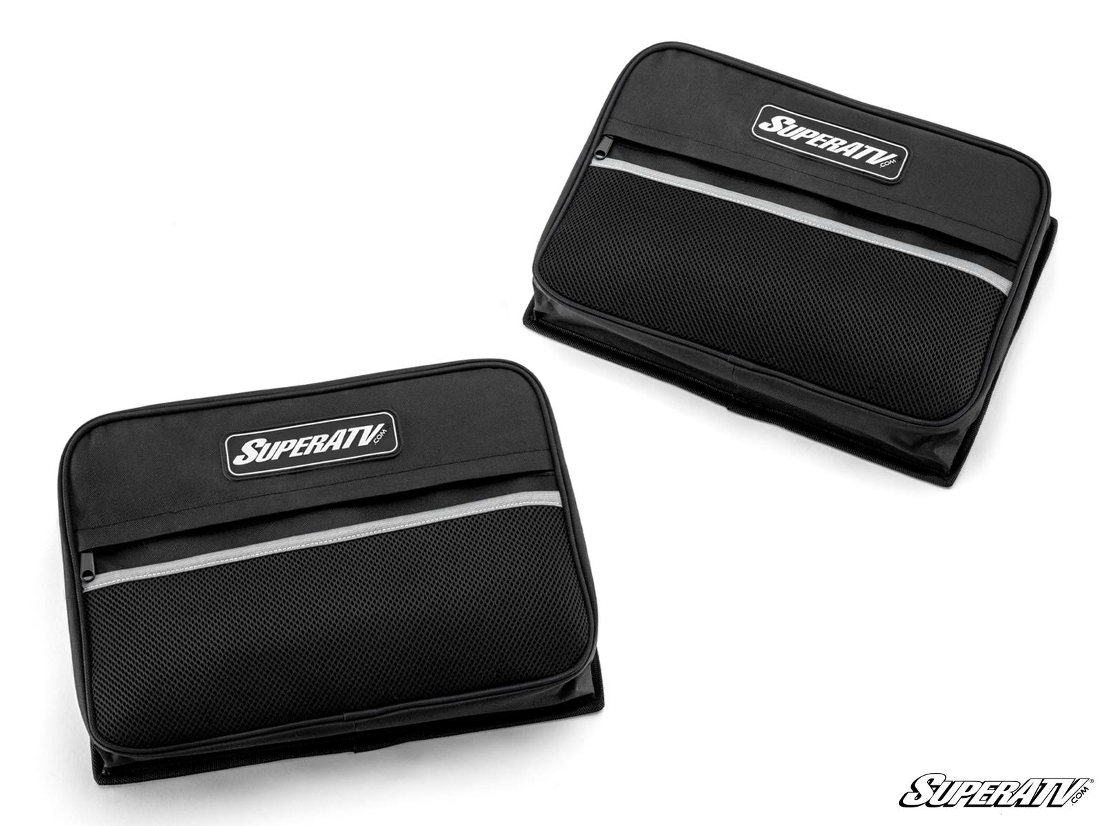 Two black Universal UTV Door Bags featuring SuperATV logo patches are displayed on a white background. The rectangular bags lie flat and include zippered closures with mesh exterior pockets.