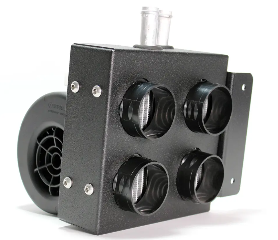 A close-up of the Inferno Cab Heater Kit With Defrost for 2014-Current Yamaha Viking shows a black metal box with four front vents, visible screws, a round blower unit behind it, and two clear tubes on top for an industrial look.