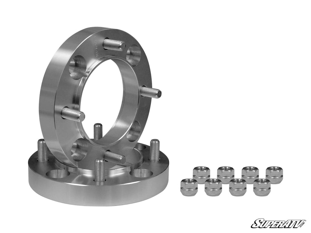 A pair of Yamaha Wheel Spacers 4/110 with pre-installed bolts stand upright and flat next to eight matching lug nuts, all on a plain white background. The SuperATV brand appears in the bottom right corner.