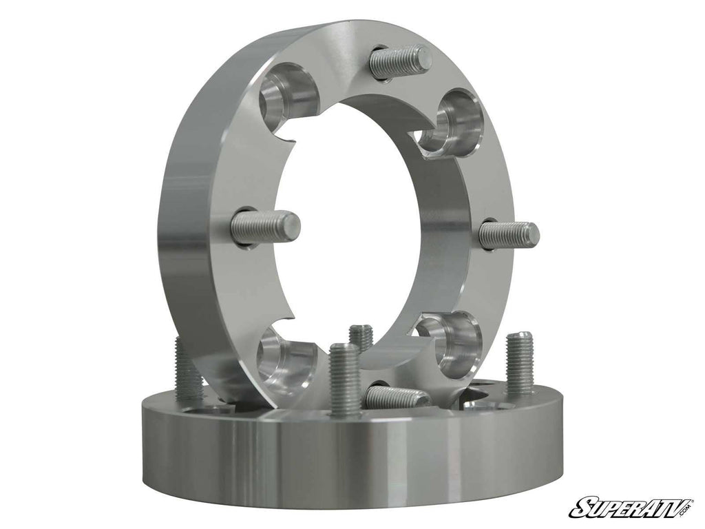 Two machined, circular Mini Truck 1 Wheel Spacers (4/110) with five threaded studs each are stacked on a white background. These metallic spacers are designed for automotive use, and the SuperATV logo is visible in the bottom right corner.