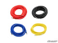 Four Black Ops Winch Wiring Kit coiled cables with metal ring terminals are displayed on a white background in red (top left), black (top right), blue (bottom left), and yellow (bottom right). The SuperATV logo is in the lower right corner.