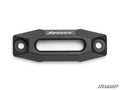A Black Ops Winch Aluminum Hawse Fairlead, black and rectangular with beveled edges and two mounting holes per side. SuperATV in white at the top center. White background with a small SuperATV logo in the lower right corner.