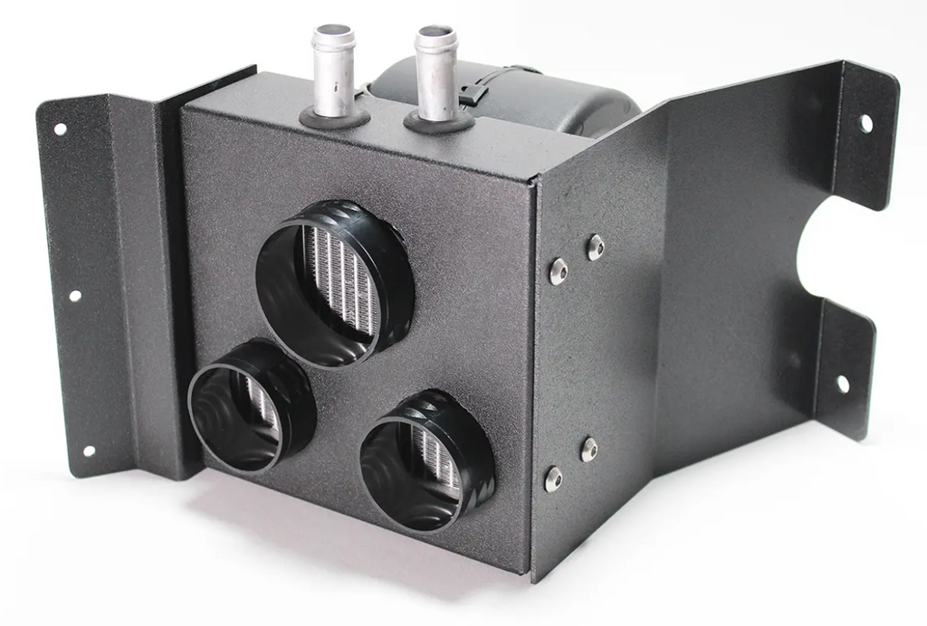 The Inferno Cab Heater Kit with Defrost for 2013-current Kubota RTV X-Series 850, 900, 1120, and 1140 features a compact black metal heater box with three front vent openings, dual top hose connections, internal core, and a bracket with mounting holes.