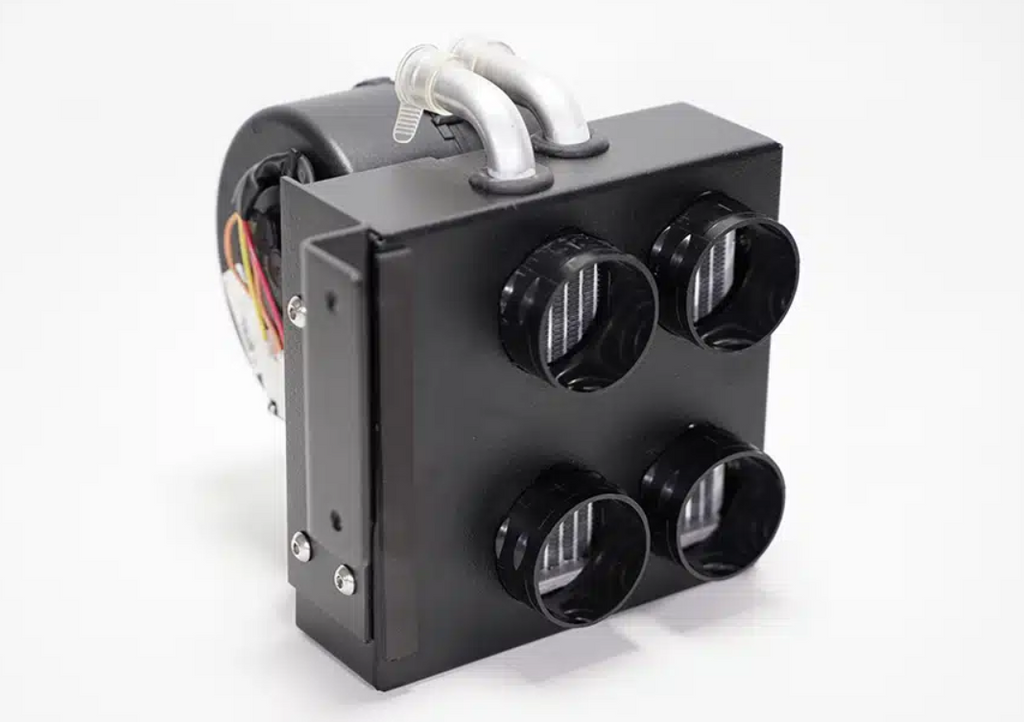 The Inferno Cab Heater Kit With Defrost for 2018-Current Yamaha Wolverine X2 & X4 is a compact black unit featuring four round air vents, two curved metal pipes on top, and visible side wiring, shown against a plain white background.