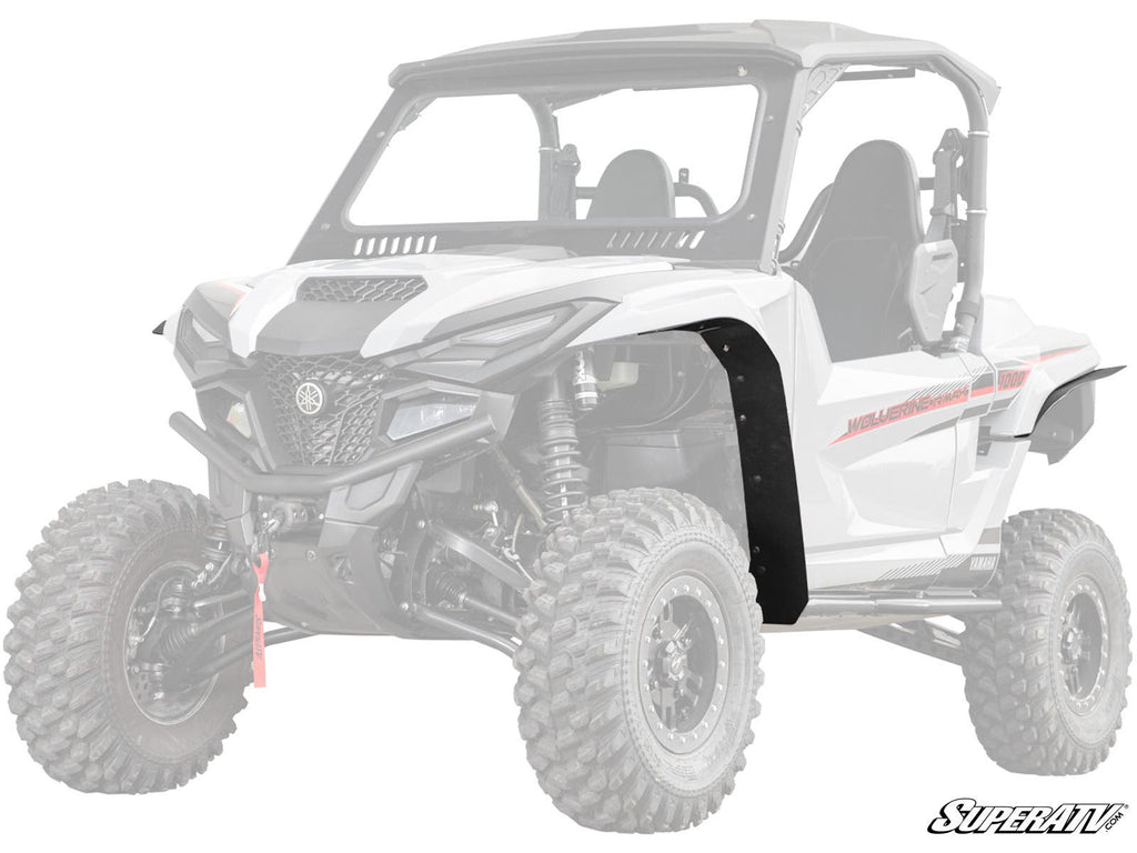 A white Yamaha Wolverine RMAX 1000 with rugged tires is shown. The left front fender features the Low Profile Fender Flare accessory. The SuperATV logo is in the bottom right, with a faded background and rear.