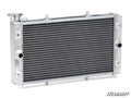 The Up & Running Yamaha Wolverine Radiator features a silver aluminum body, black horizontal cooling fins, a top left cap, multiple front hose ports, and displays the SuperATV logo in the bottom right on a white background.