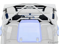Rear view of a blue Yamaha YXZ with gray SuperATV roll cage, support bars, and visible suspension springs and seats. The Yamaha logo is on the rear panel. Bottom right features the SuperATV logo. Product: Yamaha YXZ Rear Windshield.