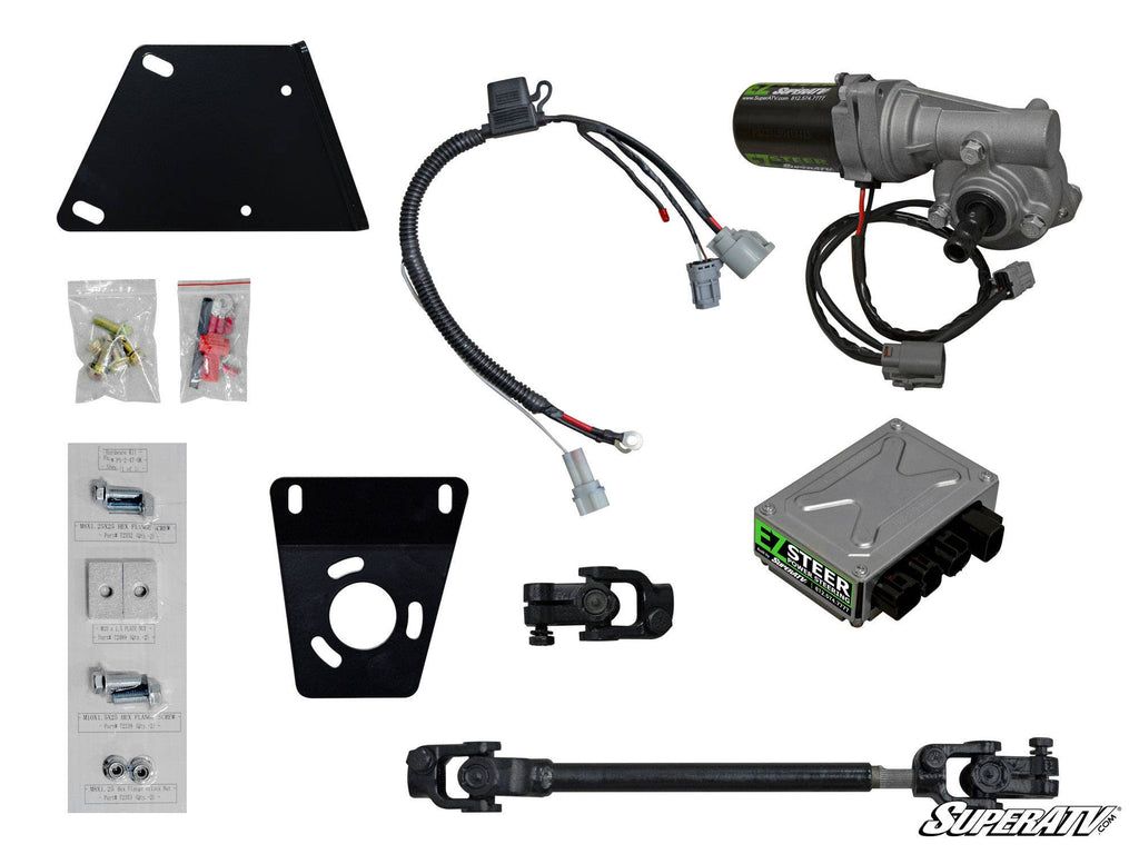The image displays the Yamaha Wolverine Power Steering Kit, featuring a motor with wiring, a SuperATV control box, mounting brackets, wiring harnesses, connectors, U-joints, bolts, hardware packets, and a steering shaft.