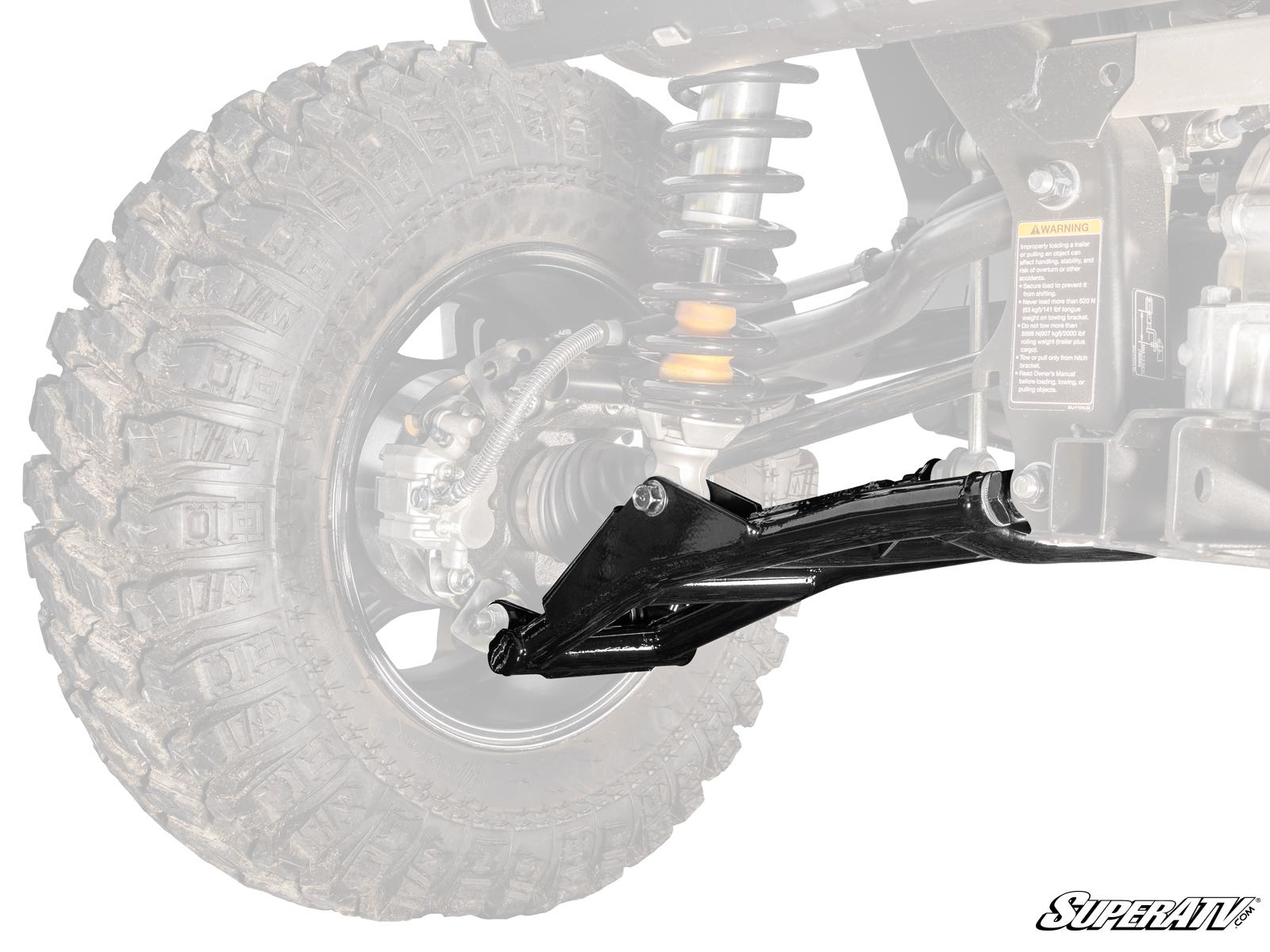 Close-up of Yamaha Wolverine X2 1000 High-Clearance Lower Rear A-Arms in black, installed on a rugged off-road vehicle. Large treaded tire and highlighted A-arm in foreground; rest of the vehicle is faded. SuperATV logo at bottom right.