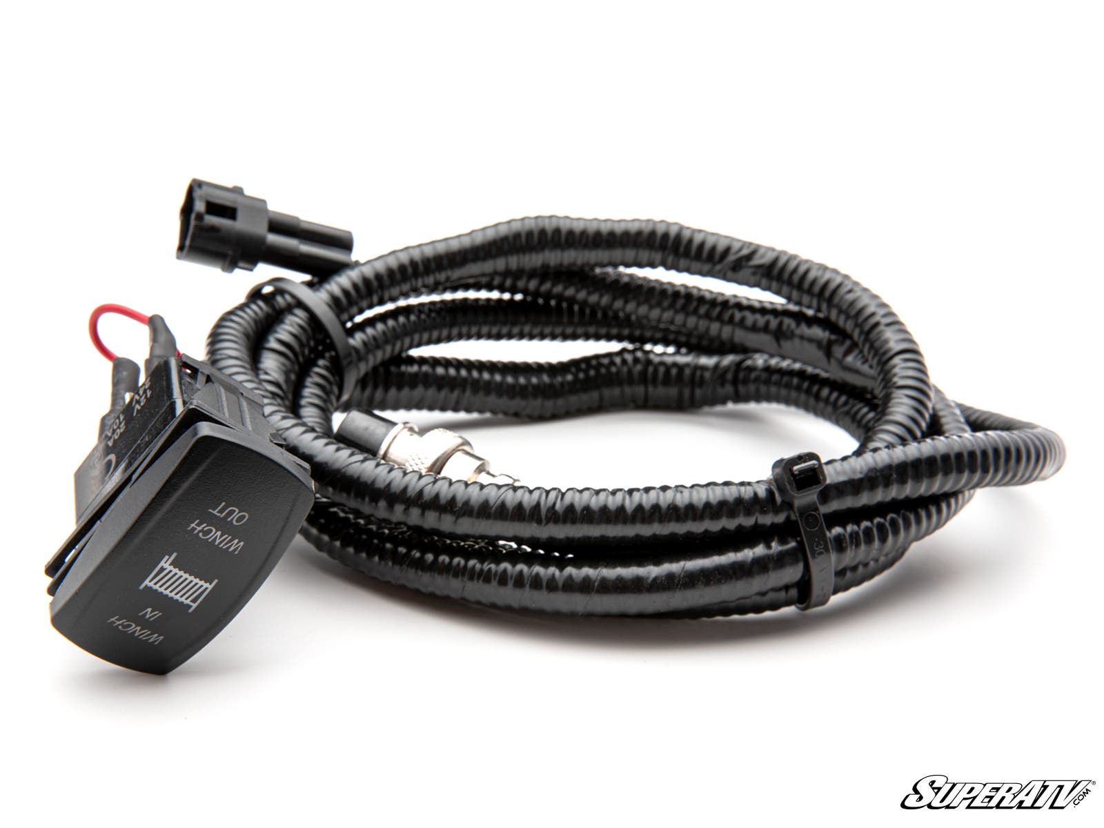 The image shows a Yamaha Wolverine RMAX Ready-Fit Winch harness: a coiled black wiring assembly with a rocker switch labeled WINCH IN/OUT, connector plug, and black corrugated tubing. White background with SuperATV branding in the corner.