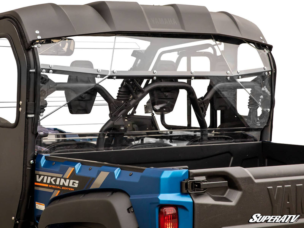 A close-up of a Yamaha Viking with a clear Yamaha Viking Rear Windshield installed, showing the roll cage, seating, and highlighting the windshield’s fit and mounting hardware on the vehicle’s rear.
