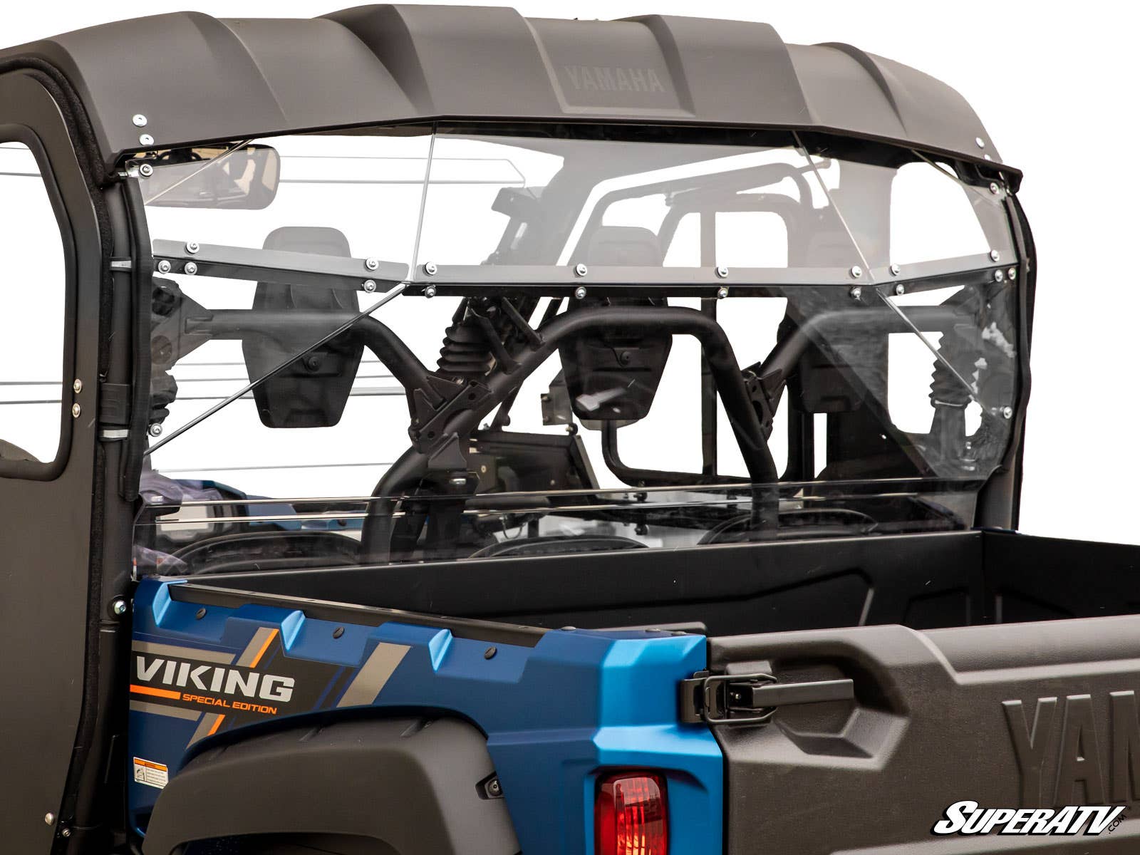 A close-up of a Yamaha Viking with a clear Yamaha Viking Rear Windshield installed, showing the roll cage, seating, and highlighting the windshield’s fit and mounting hardware on the vehicle’s rear.